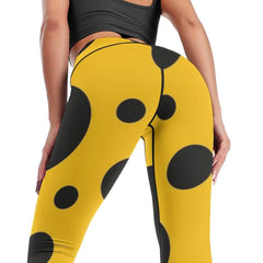 Black polka dots on yellow background Leggings